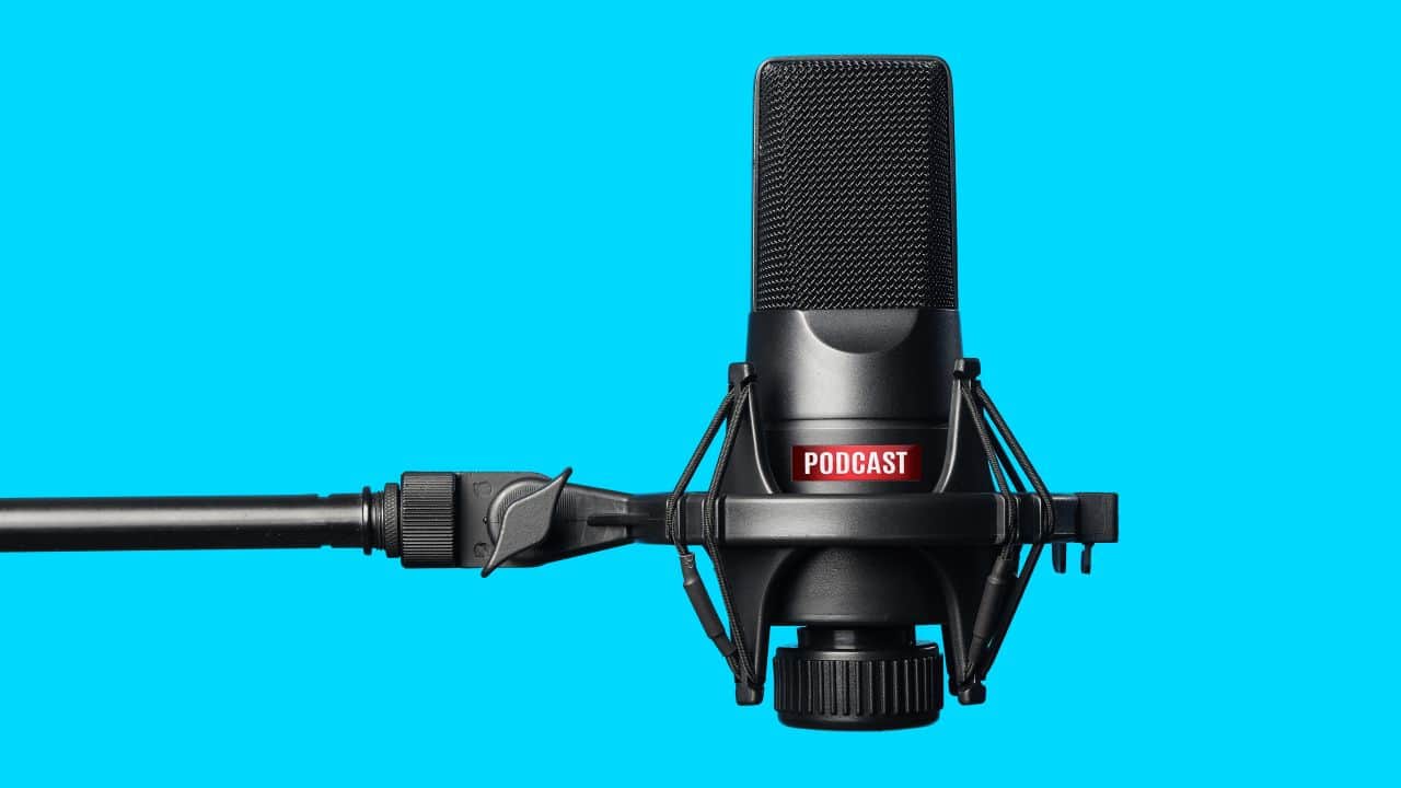 High-quality podcast microphone with shock mount on a blue background.