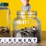 Person dropping coin into jar labeled 'Retirement' for savings.