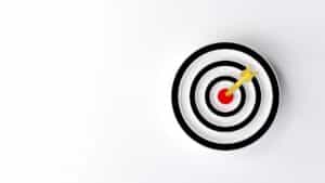Dart hitting the bullseye on a target, symbolising goal achievement.