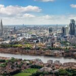 Elevated panorama of the London skyline along the river Thames from London Bridge until the City during a sunny summer day, United Kingdom