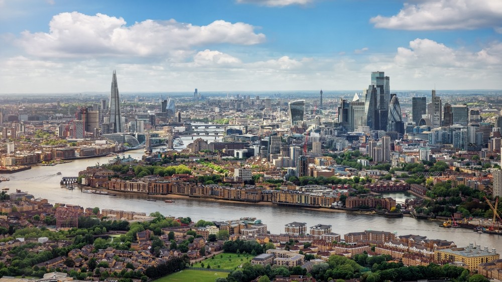 Elevated panorama of the London skyline along the river Thames from London Bridge until the City during a sunny summer day, United Kingdom