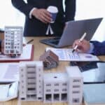 group of businessmen and investors discuss investing in real estate and jointly plan investments in construction projects of condominiums and apartments for sale and rent. investment advisory concept
