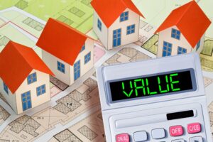 PROPERTY VALUE OF A BUILDING - WHAT DETERMINES A PROPERTY'S VALUE - Factors that affect property value - Concept with calculator and residential building model