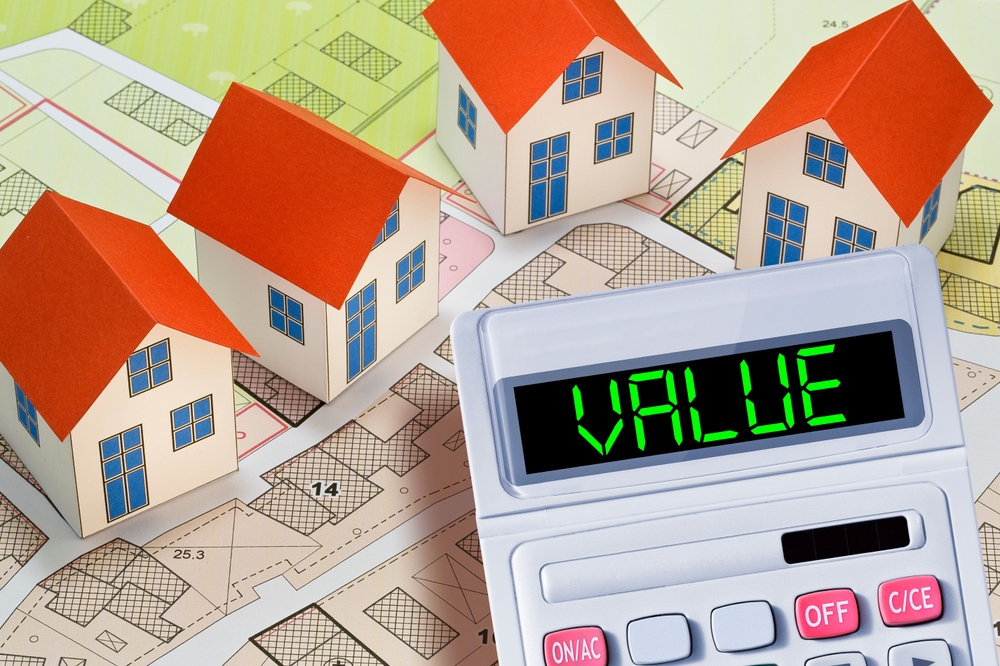 PROPERTY VALUE OF A BUILDING - WHAT DETERMINES A PROPERTY'S VALUE - Factors that affect property value - Concept with calculator and residential building model