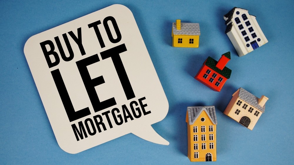 Buy To Let Mortgage text with house models on blue background
