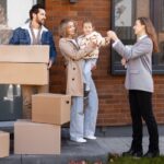Buying new dream home, a family moving and receiving keys from a real estate agent
