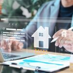 Real estate agent analyzing digital property platform on laptop with virtual house icon, rating stars, and documents. Concept of property evaluation, smart real estate, and online housing service.