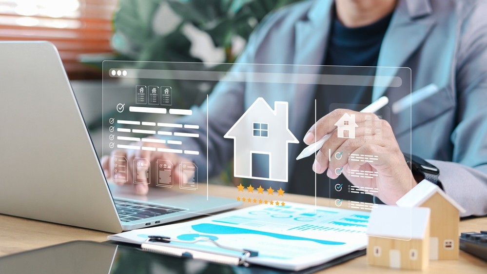 Real estate agent analyzing digital property platform on laptop with virtual house icon, rating stars, and documents. Concept of property evaluation, smart real estate, and online housing service.