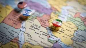 Political map of the Middle East with flag pins of USA, Israel, and Iran on key geographic locations, representing international relations and geopolitical alliance concept and war in middle east. High quality photo