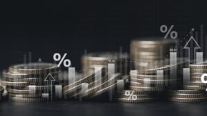 Inflation and tax concept Global economy recession. Rising inflation rates graph. Stack of coins money with financial graph report. interest rate, business, finance and investment background.