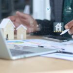 Real estate agent analyzing property investment with digital dashboard, home rating and financial data. Property valuation, housing market analysis and real estate management concept.