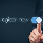 Businessman switch-on button register now, web registration concept.