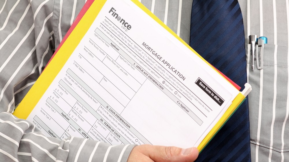 Home loan application form in hand of Agent
